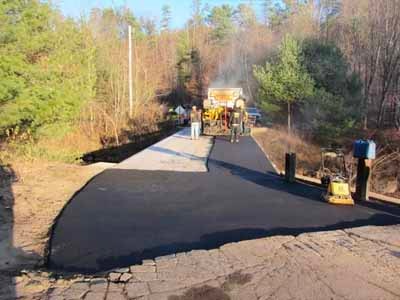 Collins Street Bridge - paving crew laying new asphalt road surface