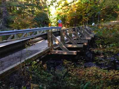 Creamery Bridge full view over rocky stream in autumn
