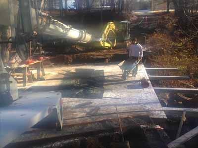 Owl Brook Bridge - concrete pump truck pouring deck with crew and excavator
