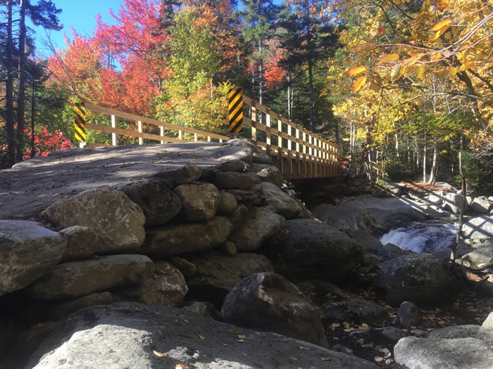 Tuckermans Trails - completed bridge with autumn foliage and stone abutments