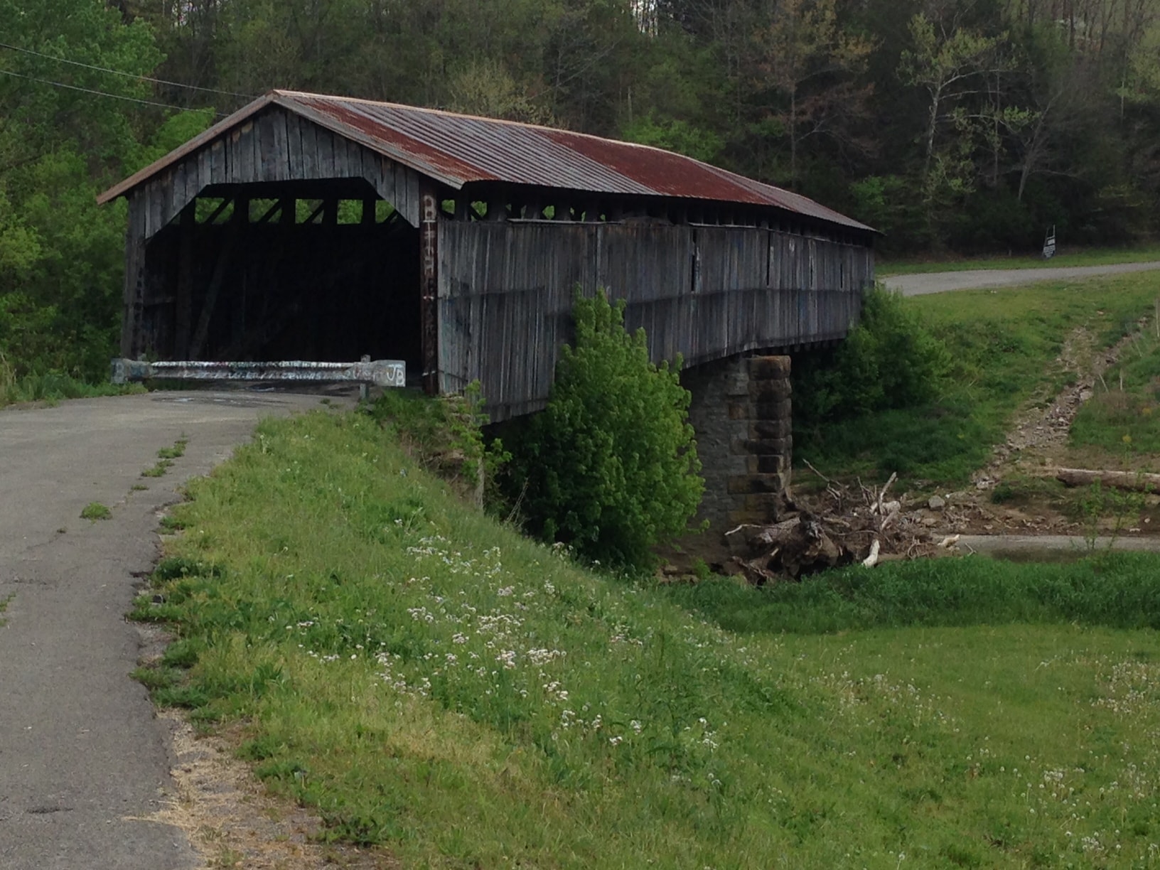 Beechfork covered bridge exterior with rusted metal roof before restoration