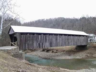 Cabin Creek covered bridge spanning creek with new metal roof after restoration