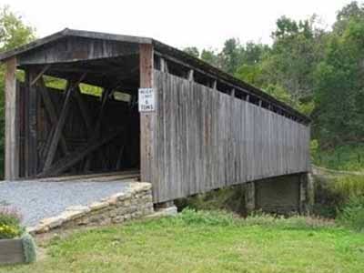 Johnson Creek covered bridge completed exterior in summer with weight limit sign