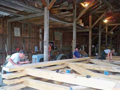 Tuscarora bridge roof trusses being assembled on rock ledge over stream