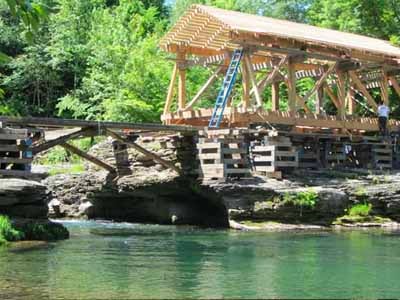Tuscarora covered bridge nearly complete with cedar shingle siding over rocky gorge